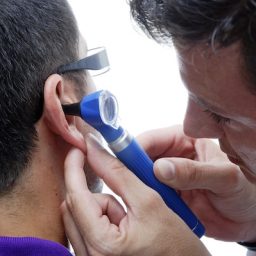 Doctor looking in an ear