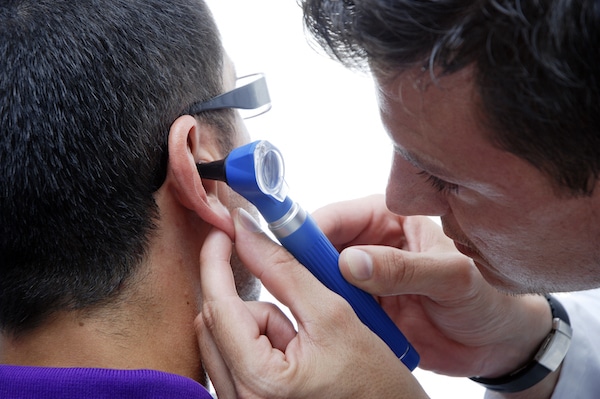 Doctor looking in an ear