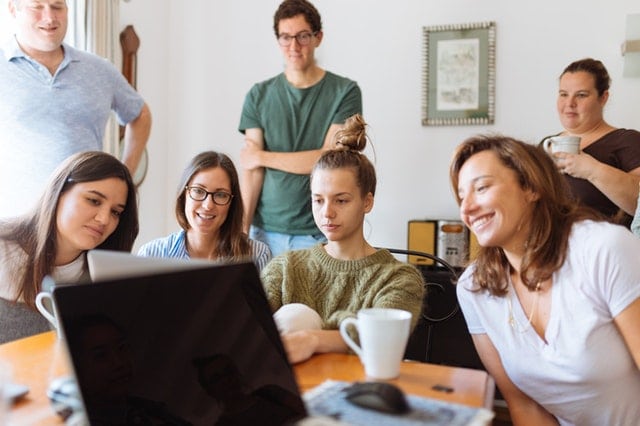 family sitting around a computer