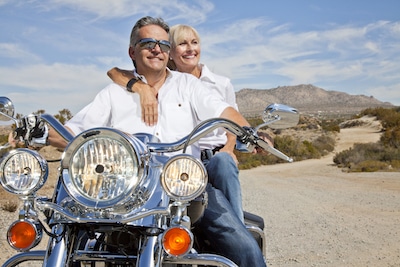 man and woman on a motorcycle 