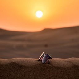 sun glasses on a dune in the desert