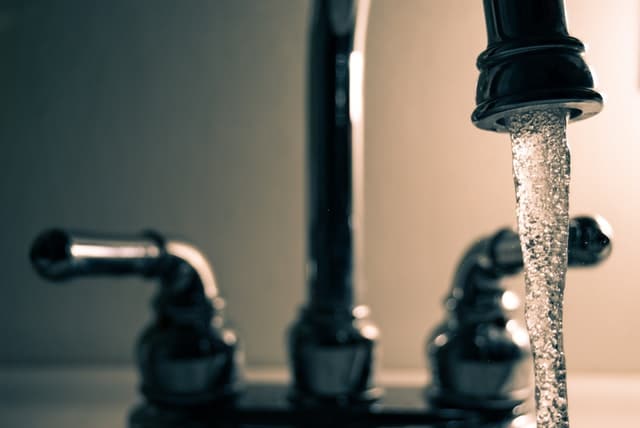 Running water from a kitchen faucet 