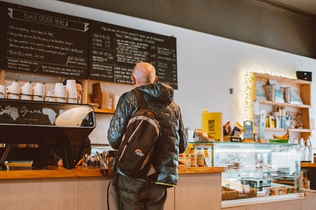 man ordering at a coffee counter