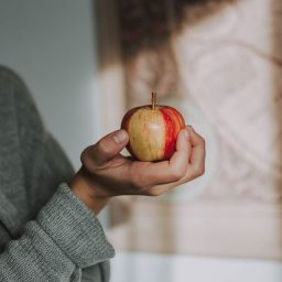 person holding an apple