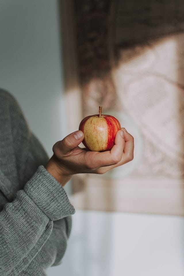 person holding an apple 