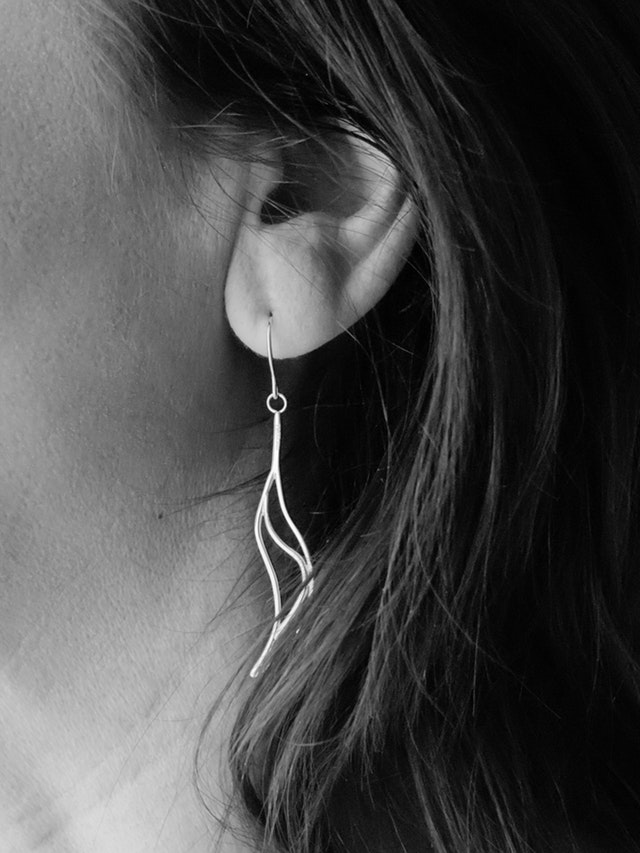 woman's ear with a large earring 