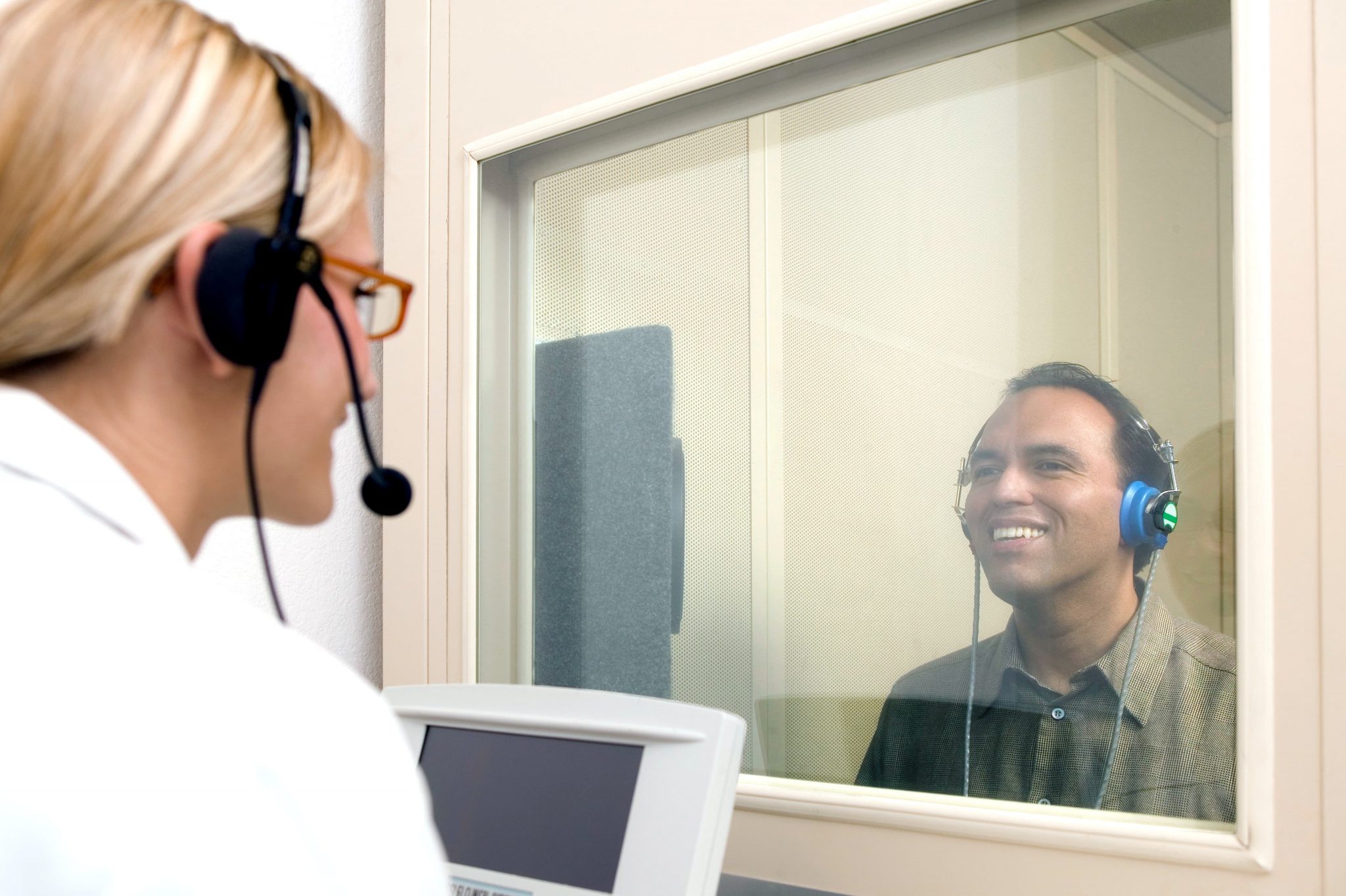 Patient with headphones receiving hearing test