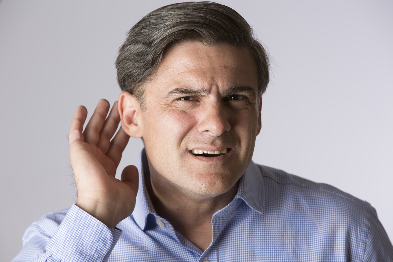 Man putting hand to ear in listening motion