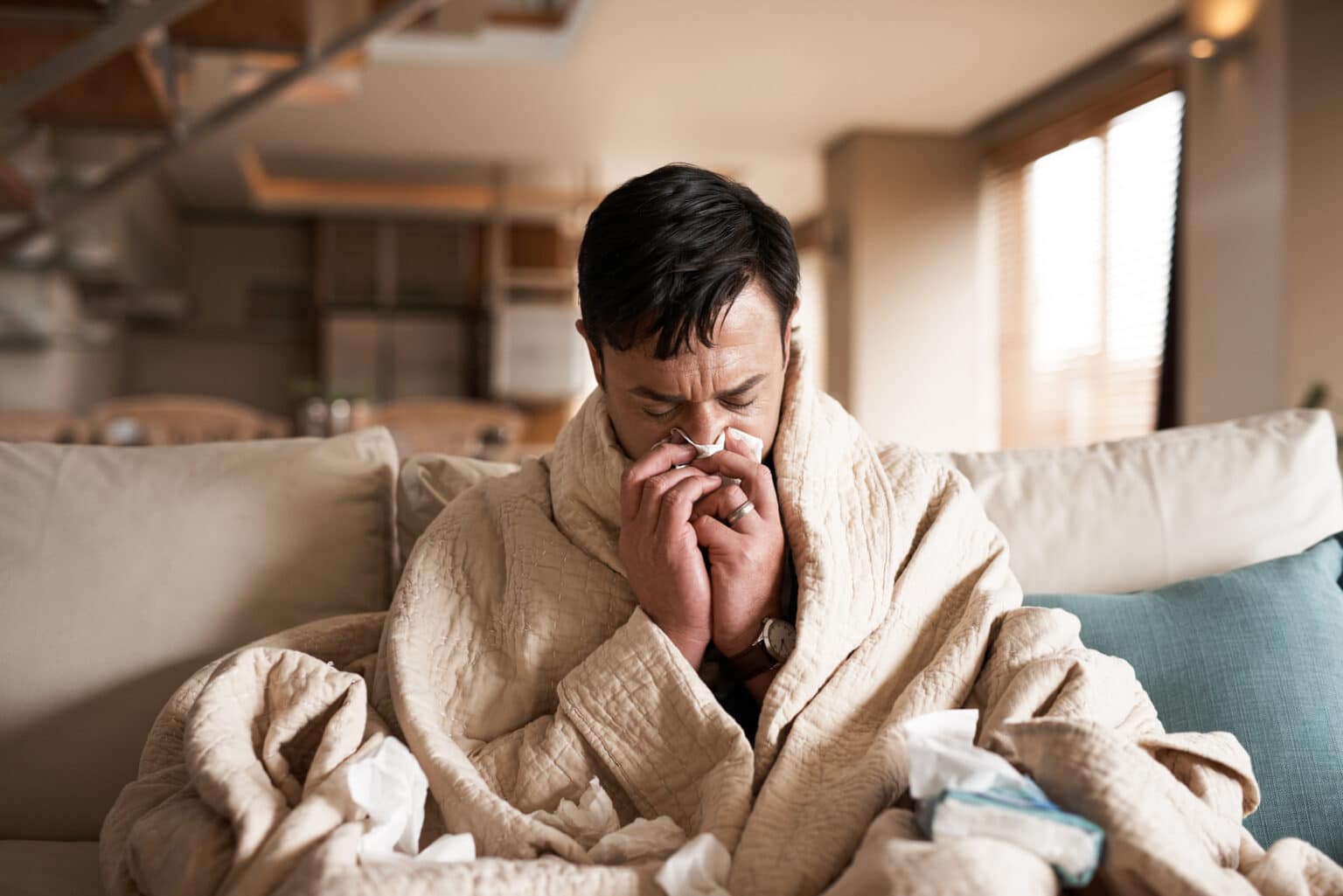 Young man sick at home with a cold.