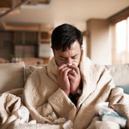 Young man sick at home with a cold.