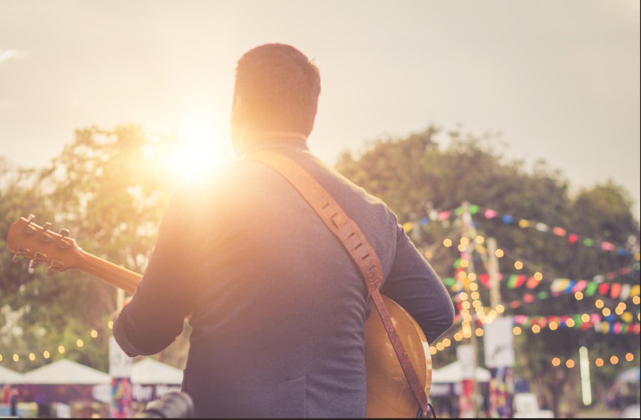 Musician playing at an outdoor festival.