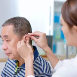 Man is fitted for hearing aids