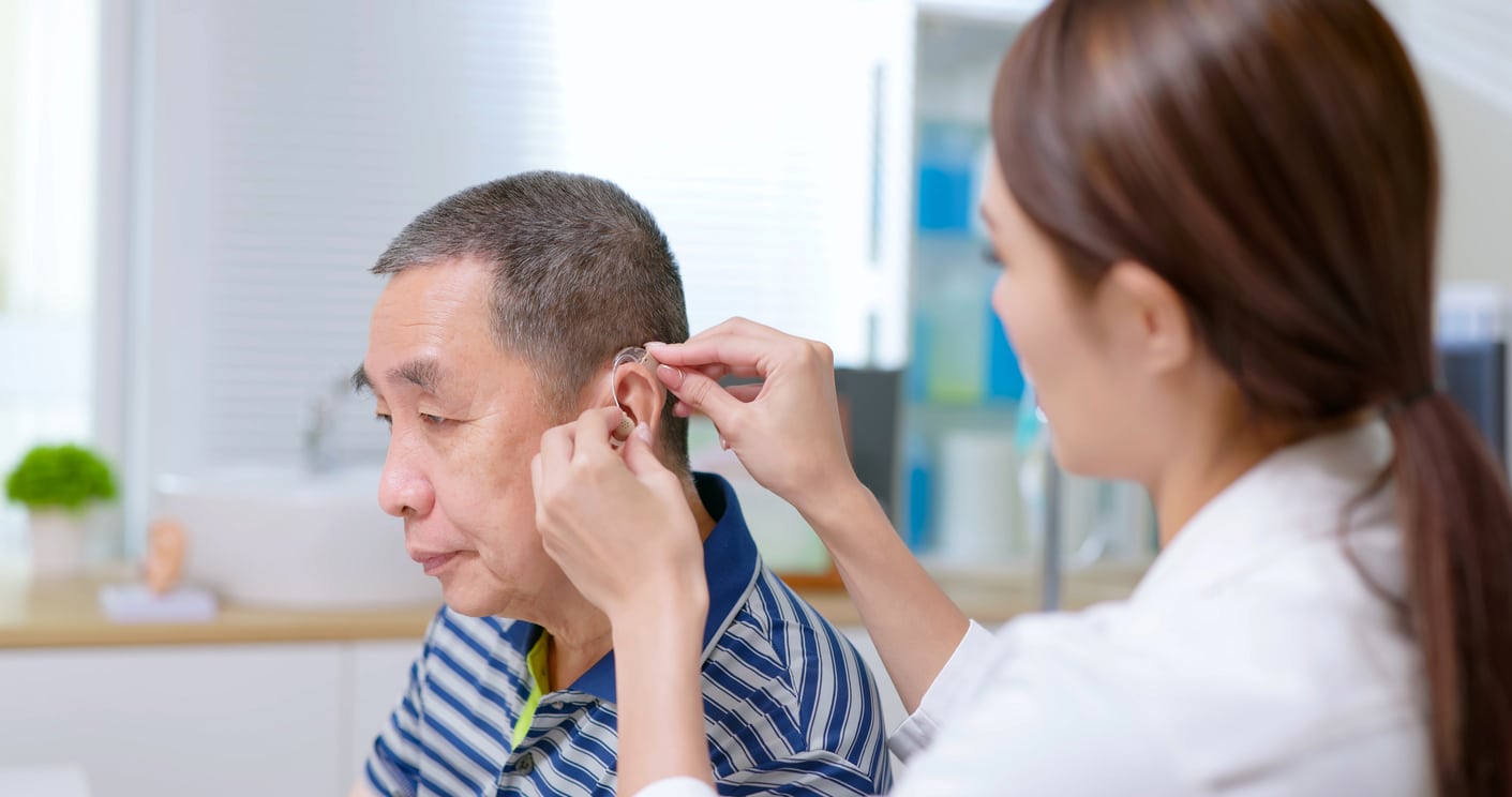 Man is fitted for hearing aid