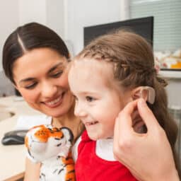 Young girl is fitted for hearing aids