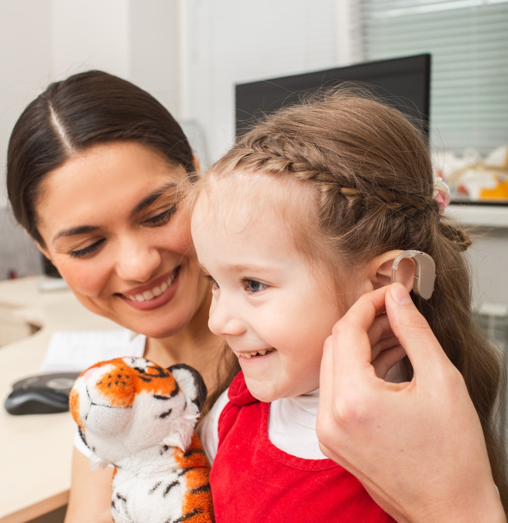 Young girl is fitted with hearing aids