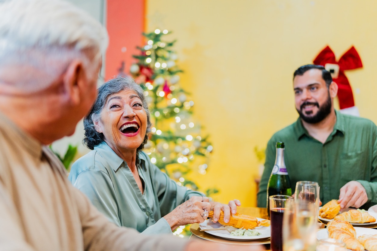 Family talking and eating during lunch on a holiday at home.